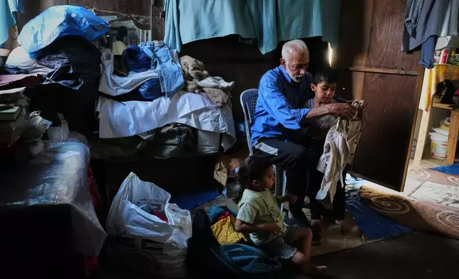 Mahmoud Nofal, 64, cares for his grandchildren, Tamim and Raneen Nofal, whom he has raised since their parents were killed in an Israeli airstrike, in Khan Younis, southern Gaza Strip, June 2, 2026. (AP Photo/Abdel Kareem Hana)