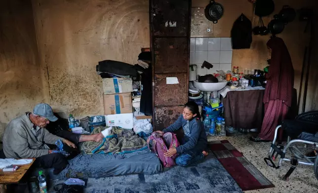 Eleven-year-old Ghazal al-Kibritti, who lost her parents and three siblings in an Israeli airstrike, prepares her school bag at her grandparents' home in Gaza City, Sunday, April 26, 2026. (AP Photo/Jehad Alshrafi)