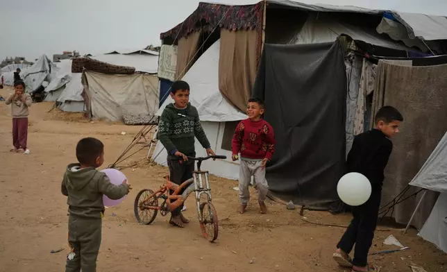 Palestinian children play at an orphanage camp in Khan Younis, southern Gaza Strip, Thursday, Feb.12, 2026. (AP Photo/Jehad Alshrafi)