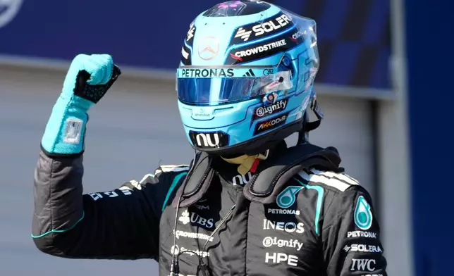 Mercedes driver George Russell of Britain celebrates after setting the pole position during the qualifying session ahead of the Austrian F1 Grand Prix, in Spielberg, Austria, Saturday, June 27, 2026. (AP Photo/Darko Bandic)