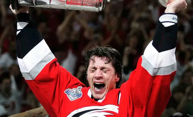 FILE - Carolina Hurricanes captain Rod Brind'Amour celebrates with the Stanley Cup after winning Game 7 of the Stanley Cup Finals over the Edmonton Oilers, in Raleigh, N.C., June 19, 2006. (AP Photo/Ryan Remiorz, File)