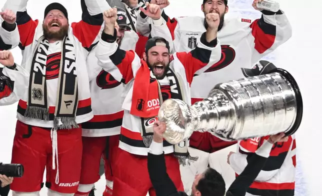The Carolina Hurricanes celebrates after a win over the Vegas Golden Knights in Game 6 of the NHL hockey Stanley Cup Final series, Sunday, June 14, 2026, in Las Vegas. (AP Photo/Candice Ward)