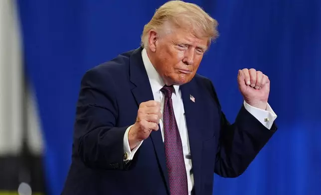 President Donald Trump dances on stage at a Mack Trucks facility, Tuesday, June 23, 2026, in Macungie, Pa. (AP Photo/Julia Demaree Nikhinson)