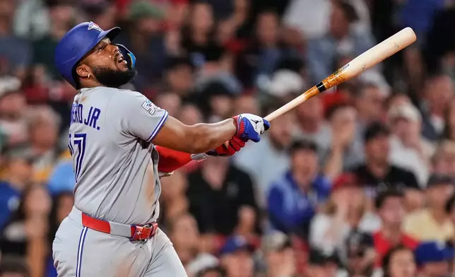 Toronto Blue Jays' Vladimir Guerrero Jr. watches the flight of his RBI single during the eighth inning of a baseball game against the Boston Red Sox, Wednesday, June 17, 2026, in Boston. (AP Photo/Charles Krupa)