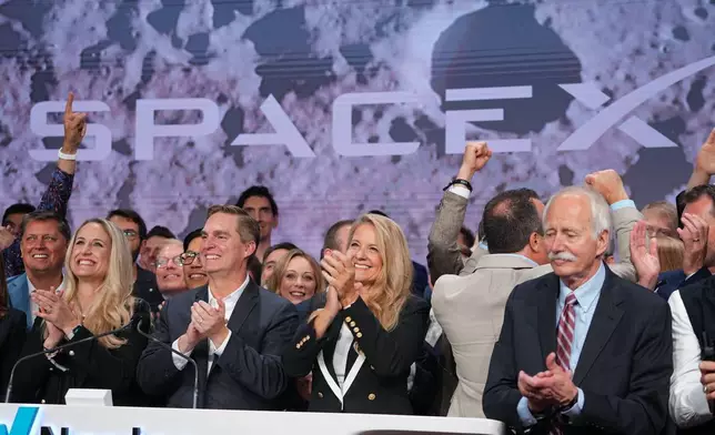 Gwynne Shotwell, President and COO of SpaceX celebrates with colleagues during a bell ringing ceremony for the IPO of SpaceX at the Nasdaq MarketSite in New York, Friday, June 12, 2026, in New York. (AP Photo/Frank Franklin II)