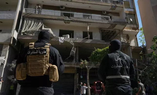 Members of the Lebanese Army Intelligence stand guard in front of an apartment that was struck in an Israeli airstrike in Dahiyeh, Beirut's southern suburbs, Lebanon, Sunday, June 14, 2026. (AP Photo/Bilal Hussein)