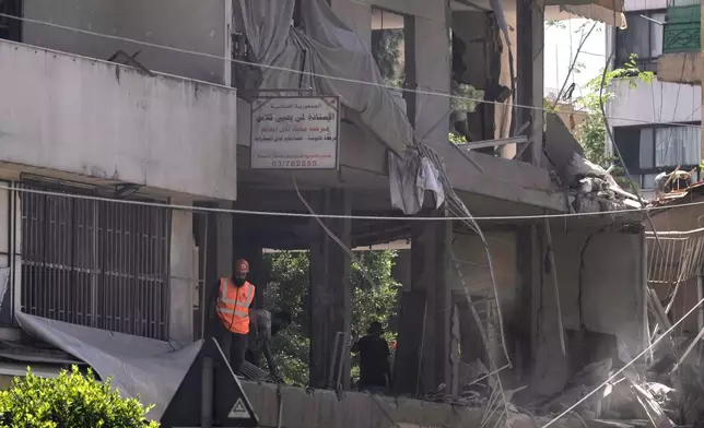 A rescue worker checks an apartment that was hit in an Israeli airstrike in Dahiyeh, Beirut's southern suburbs, Lebanon, Sunday, June 14, 2026. (AP Photo/Bilal Hussein)