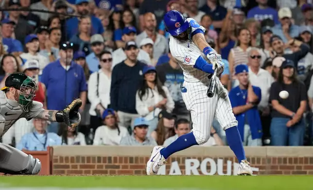 Chicago Cubs' Dansby Swanson hits a one-run single during the ninth inning of a baseball game against the Athletics in Chicago, Thursday, June 4, 2026. (AP Photo/Nam Y. Huh)