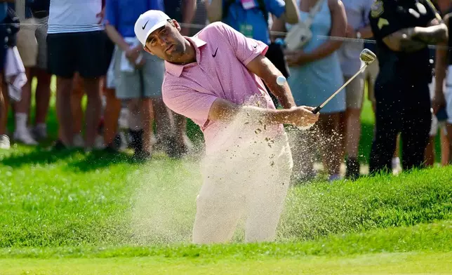 Scottie Scheffler hits out of a bunker at the fifth hole during the final round of the Travelers Championship golf tournament at TPC River Highlands, Sunday, June 28, 2026, in Cromwell, Conn. (AP Photo/Jessica Hill)