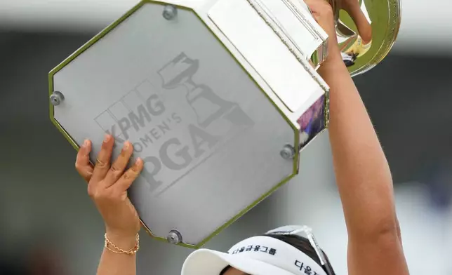 Haeran Ryu, of South Korea, celebrates with the trophy after winning the Women's PGA Championship golf tournament at Hazeltine National Golf Club, Sunday, June 28, 2026, in Chaska, Minn. (AP Photo/Matt York)