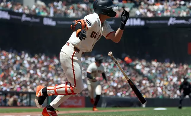 San Francisco Giants' Jung Hoo Lee watches his three-run triple against the Athletics during the sixth inning of a baseball game in San Francisco, Thursday, June 25, 2026. (AP Photo/Jed Jacobsohn)