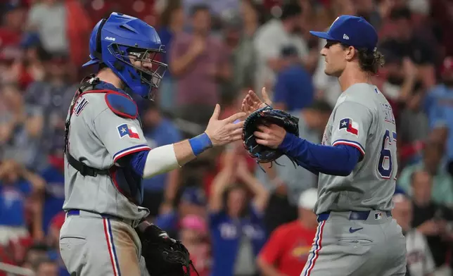 Texas Rangers pitcher Jacob Latz, right, and catcher Danny Jansen celebrate a victory over the St. Louis Cardinals following a baseball game Monday, June 1, 2026, in St. Louis. (AP Photo/Jeff Roberson)