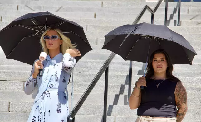 Paris Hilton, left, stands alongside Aleah Corona, the mother of a student injured at the Provo Canyon School, during a news conference Monday, June 15, 2026, in Provo, Utah. (AP Photo/Hannah Schoenbaum)