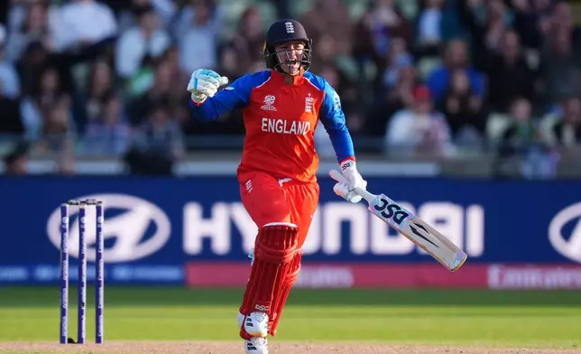 England's Danni Wyatt-Hodge celebrates reaching her century during the ICC Women's T20 World Cup, Group 2 match between England and Sri Lanka, at Edgbaston, Birmingham, England, Friday June 12, 2026. (Mike Egerton/PA via AP)