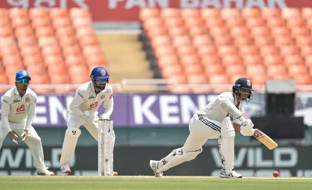 India's Washington Sundar, right, bats on day two of the cricket test match between Afghanistan and India in New Chandigarh, India, Sunday, June 7, 2026. (AP Photo/Ashwini Bhatia)
