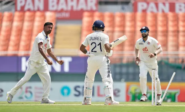 India's Dhruv Jurel, center, is bowled out by Afghanistan's Mohammad Saleem, left, on day two of the cricket test match between Afghanistan and India in New Chandigarh, India, Sunday, June 7, 2026. (AP Photo/Ashwini Bhatia)