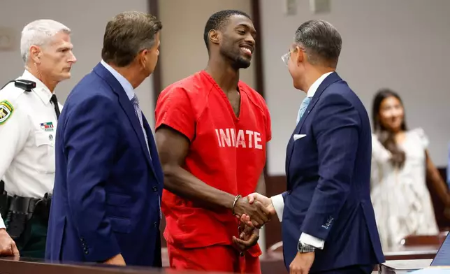Terrion Arnold, a Detroit Lions cornerback, shakes hands with his attorneys R. Timothy Jansen, left, and A.J. Alvarez, during the conclusion of his pretrial detention hearing at the Hillsborough County Courthouse on Monday, June 29, 2026, in Tampa, Fla. (Jefferee Woo/Tampa Bay Times via AP)