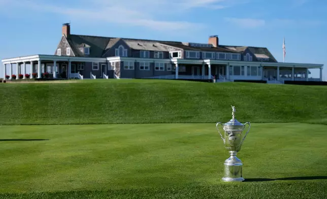 FILE - The U.S. Open Golf Championship trophy is displayed in front of the clubhouse at Shinnecock Hills Golf Club in Southampton, N.Y., Sept. 15, 2025. (AP Photo/Seth Wenig, File)