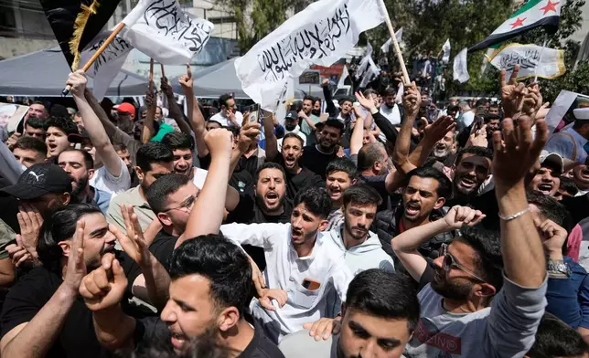 FILE - Sunni Muslims wave religious flags during a protest against the clause in a proposed amnesty law that would exclude some prisoners from being eligible for amnesty, after Friday prayers in Beirut, Lebanon, Friday, May 22, 2026. (AP Photo/Bilal Hussein, File)