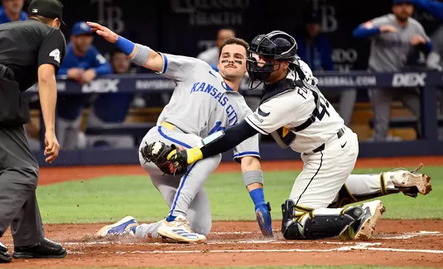 Kansas City Royals' Michael Massey scores on a Lane Thomas double before the tag from Tampa Bay Rays catcher Nick Fortes (40) during the second inning of a baseball game, Monday, June 22, 2026, in St. Petersburg, Fla. (AP Photo/Jason Behnken)