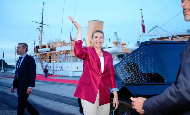 Acting Prime Minister Mette Frederiksen, center, waves on the royal ship Dannebrog on Monday, June 1, 2026, as the royal ship Dannebrog is docked at Odense Harbor. (Sebastian Elias Uth/Ritzau Scanpix via AP)