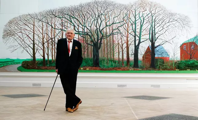 FILE - British artist David Hockney poses as he unveils his painting 'Bigger Trees Near Water', the largest painting ever shown at the Royal Academy's Summer Exhibition, London, Friday, May 25, 2007. (AP Photo/Sang Tan, File)