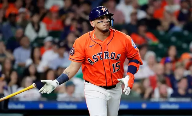 Houston Astros designated hitter Isaac Paredes flips his bat as he watches his hit against the Athletics during the third inning of a baseball game Friday, June 5, 2026, in Houston. (AP Photo/Michael Wyke)