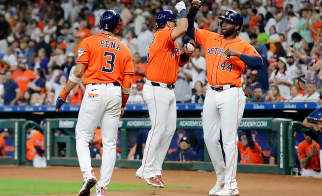 Houston Astros Jeremy Peña (3), designated hitter Isaac Paredes (15) and Yordan Alvarez (44) celebrate after they all score on the three run home run by Paredes against the Athletics during the first inning of a baseball game Friday, June 5, 2026, in Houston. (AP Photo/Michael Wyke)
