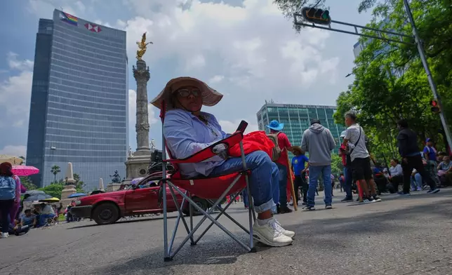Teachers stage a protest at the Angel of Independence to demand salary increases in Mexico City, Tuesday, June 2, 2026. (AP Photo/Marco Ugarte)