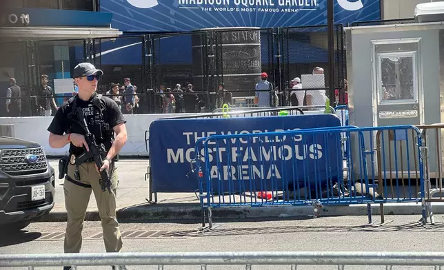 A Secret Service agent stands watch outside Madison Square Garden in New York, Monday, June 8, 2026, as President Donald Trump is set to attend Game 3 of the NBA Finals basketball series between the New York Knicks and the San Antonio Spurs. (AP Photo/Ted Shaffrey)