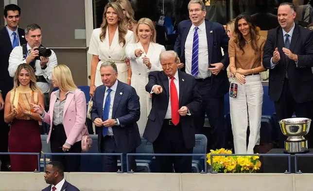 FILE - President Donald Trump, center, attends the men's singles final at the U.S. Open tennis tournament, Sept. 7, 2025, in New York. (AP Photo/Manuel Balce Ceneta, File)