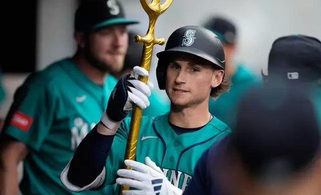 Seattle Mariners' Colt Emerson celebrates in the dugout after hitting a home run in the third inning of a baseball game against the Cleveland Guardians in Cleveland, Friday, June 26, 2026. (AP Photo/Sue Ogrocki)