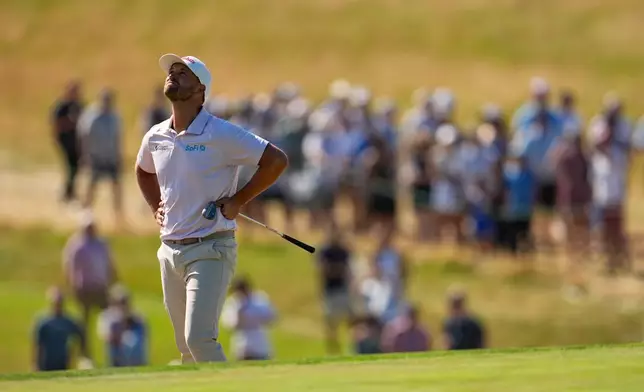 Wyndham Clark reacts to his shot on the ninth hole during the final round of the U.S. Open golf tournament at Shinnecock Hills Golf Club in Southampton, N.Y., Sunday, June 21, 2026. (AP Photo/George Walker IV)