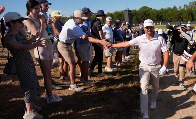 Wyndham Clark greets fans during the final round of the U.S. Open golf tournament at Shinnecock Hills Golf Club in Southampton, N.Y., Sunday, June 21, 2026. (AP Photo/George Walker IV)