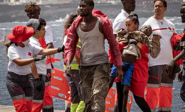 FILE - Migrants disembark at the port of "La Estaca" in Valverde on the Canary island of El Hierro, Spain, Aug. 26, 2024. Emergency services said the migrants arrived by boat after a 13-day voyage from Senegal. (AP Photo/Maria Ximena, File)