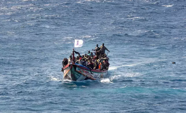 FILE - Migrants crowd a wooden boat as they sail to the port in La Restinga on the Canary island of El Hierro, Spain, Sunday, Aug. 18, 2024. (AP Photo/Maria Ximena, File)