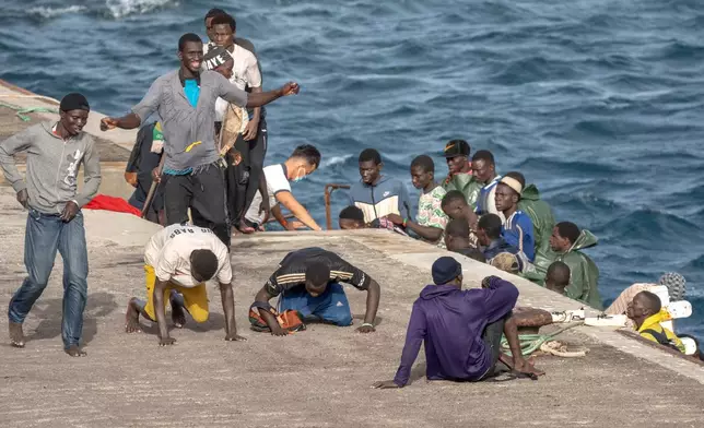 FILE - Migrants react as they arrive at the port in La Restinga on the Canary island of El Hierro, Spain, on, Aug. 19, 2024. (AP Photo/Maria Ximena, File)