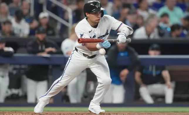 Miami Marlins' Javier Sanoja bunts the ball in the second inning of a baseball game against the Tampa Bay Rays Saturday, June 6, 2026, in Miami. (AP Photo/Marta Lavandier)