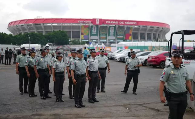 Police officers stand in formation outside the stadium in Mexico City, Wednesday, June 10, 2026, a day before it hosts the opening FIFA World Cup match between Mexico and South Africa. (AP Photo/Eduardo Verdugo)