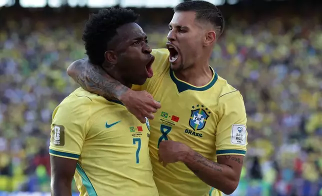 Brazil's Vinicius Junior (7) celebrates with teammate Bruno Guimaraes (8) after scoring during the World Cup Group C soccer match against Morocco in East Rutherford, N.J., near New York, Saturday, June 13, 2026. (AP Photo/Matt Slocum)