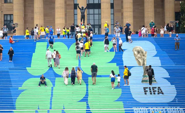 Brazilian and other soccer fans climb the steps leading to the Rocky statue, marked with a FIFA World Cup logo, in Philadelphia, on Thursday, June 18, 2026, ahead of Friday's FIFA World Cup Group C match between Brazil and Haiti. (Jose F. Moreno/The Philadelphia Inquirer via AP)/The Philadelphia Inquirer via AP)