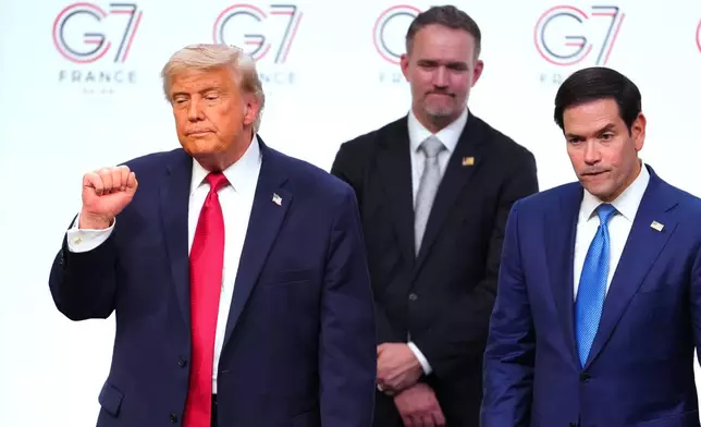 U.S. President Donald Trump, left, leaves the stage with, from right, United States Secretary of State Marco Rubio and U.S Trade Representative Jamieson Greer after a media conference at the end of the G7 summit in Evian-les-Bains, France, Wednesday, June 17, 2026. (AP Photo/Vadim Ghirda)
