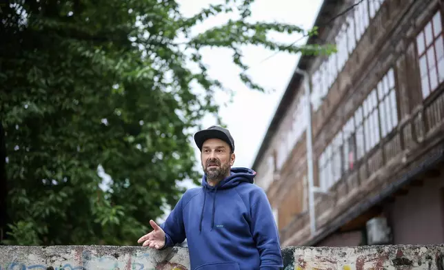 Brano Jakubovic, a member of Bosnian band Dubioza kolektiv, speaks during an interview for The Associated Press at a soccer playground where the video for the song "I Am From Bosnia, Take Me to America" was filmed, in Sarajevo, Bosnia, Thursday, June 11, 2026. (AP Photo/Armin Durgut)