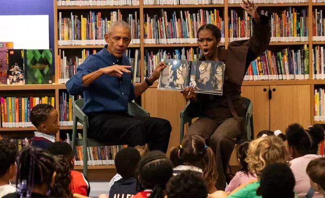 Former President Barack Obama and former first lady Michelle Obama read "Where the Wild Things Are" to students from William H. Ray Elementary School at the Obama Presidential Center's Chicago Public Library branch, Friday, June 19, 2026. (Ashlee Rezin /Chicago Sun-Times via AP, Pool)