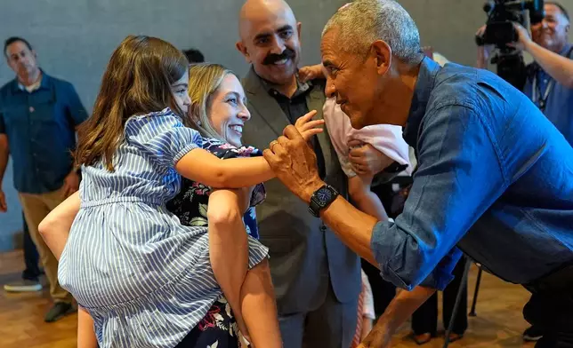 Former President Barack Obama greets the first group of visitors at the official opening of the Obama Presidential Center in Chicago, Friday, June 19, 2026. (AP Photo/Pablo Martinez Monsivais, Pool)