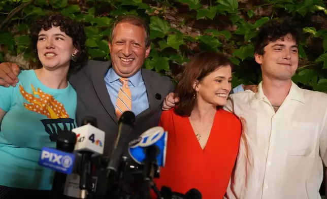 Democratic congressional candidate Brad Lander poses for photos with his family during an election night watch party Tuesday, June 23, 2026, in New York. (AP Photo/Ryan Murphy)