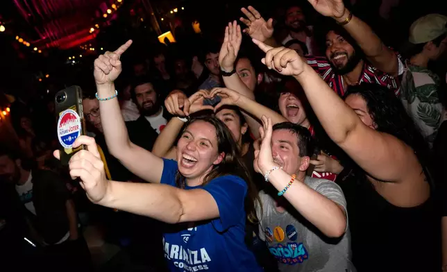 Supporters for Democratic congressional candidate Darializa Avila Chevalier celebrate during an election night watch party Tuesday, June 23, 2026, in New York. (AP Photo/Seth Wenig)