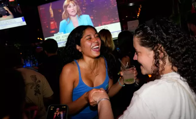 Supporters for Democratic congressional candidate Darializa Avila Chevalier celebrate during an election night watch party Tuesday, June 23, 2026, in New York. (AP Photo/Seth Wenig)