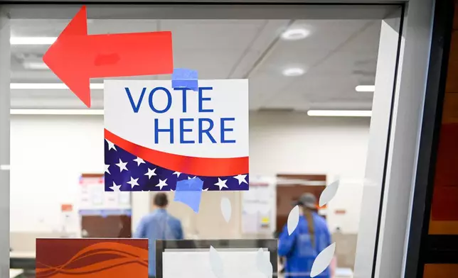 A sign hangs at a voting center during Utah's primary election on Tuesday, June 23, 2026, in Salt Lake City. (AP Photo/Alex Goodlett)