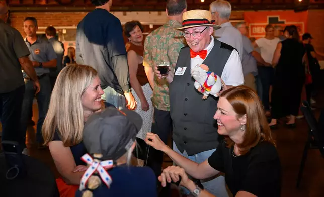 Donna Gunn, center, speaks to supporters for democratic congressional candidate Ben McAdams during a watch party for Utah's primary election on Tuesday, June 23, 2026, in Salt Lake City. (AP Photo/Alex Goodlett)